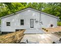 Rear exterior view highlighting the light gray siding, black trim windows and door, creating a clean and inviting aesthetic at 8576 Riser Dr, , IN 46164