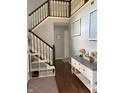 Inviting foyer features staircase with white railing, wood floors, and neutral decor at 8926 Durban Ct, Indianapolis, IN 46234