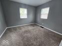 Bedroom with new carpeting, neutral paint, and bright windows at 927 Cecil Ave, Indianapolis, IN 46219
