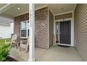 Inviting front porch area featuring comfortable seating and a 'Welcome' sign near the front door at 10118 Falls Canyon Ln, Indianapolis, IN 46229
