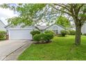 Charming home featuring a white garage door and landscaped front yard at 10262 Carmine Dr, Noblesville, IN 46060