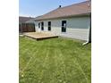 Wide open backyard space with a small wooden deck and a partial wooden fence at 12307 Chiseled Stone Dr, Fishers, IN 46037