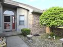 Close up of the front door with decorative glass and lovely landscaping at 1311 Aaron Dr, Shelbyville, IN 46176