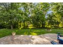 Lush backyard with a stamped concrete patio, inviting fire pit, mature trees, and landscaped area at 1343 Turfway Dr, Avon, IN 46123