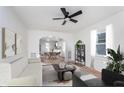 Bright, open living area with modern furnishings, a ceiling fan, and seamless flow to the dining area at 1409 N Chester Ave, Indianapolis, IN 46201