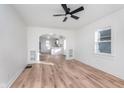 Bright living room with light wood flooring, white walls, and archway connecting to kitchen at 1409 N Chester Ave, Indianapolis, IN 46201