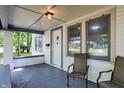 Inviting front porch with seating, offering a view of the neighborhood and classic architectural details at 1511 E Edwards Ave, Indianapolis, IN 46227