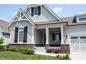 Beautiful craftsman-style home with a covered porch, brick accents, and a well-maintained front yard at 1590 Birchfield Dr, Westfield, IN 46074