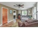 Cozy living room featuring neutral wall colors, a ceiling fan, hardwood floors, and natural light at 1727 S Irvington Ave, Indianapolis, IN 46203