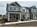 Modern townhomes with gray and white siding, stone accents, and covered entryways at 19571 Grassy Branch Dr, Westfield, IN 46074