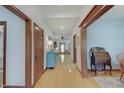 Bright hallway showcasing wood trim, hardwood floors, and decorative furniture at 214 W Stoney Trl, Greenfield, IN 46140