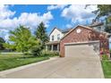 A spacious two-story home featuring a two-car garage and driveway, complemented by a well-manicured lawn at 2211 Willowview Dr, Indianapolis, IN 46239