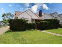 Charming home with mature landscaping, a walkway leading to the front door, and a well-maintained lawn at 2309 Maple St, Columbus, IN 47201