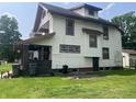 The house has a side door and a brick porch, and it has a nice, green yard at 24 Hendricks Pl, Indianapolis, IN 46201