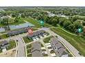 An aerial shot of lovely townhomes with nearby green spaces and a tranquil pond at 2892 Maricopa Blvd, Whitestown, IN 46075