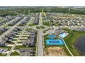 Aerial view of a residential community with a pool, basketball court, and roundabout at 2892 Maricopa Blvd, Whitestown, IN 46075