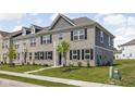 Stylish townhouse with a mix of brick and gray siding, complemented by a neat front yard at 2892 Maricopa Blvd, Whitestown, IN 46075