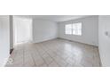 Living room with a large window and tiled floor, creating a bright and inviting atmosphere at 3817 Strathmore Dr, Indianapolis, IN 46235