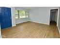 This sun-filled living room features wood-look flooring, neutral paint, and a large window at 3922 N Irvington Ave, Indianapolis, IN 46226