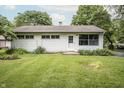 Well-maintained home featuring a well-manicured lawn, mature trees, and cozy curb appeal at 4020 Alden Ave, Indianapolis, IN 46221