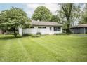 Well-maintained home with a lush green lawn, mature trees, and cozy curb appeal at 4020 Alden Ave, Indianapolis, IN 46221