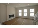 Bright living room with modern fireplace and large windows for lots of natural light at 4161 Barrel Ln, Westfield, IN 46062