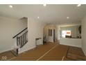 Spacious living room featuring an open layout with a staircase and new wood flooring at 4161 Barrel Ln, Westfield, IN 46062
