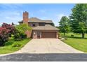 Attached two-car garage with brick exterior and a paved driveway at 4287 Gibbs Rd, Danville, IN 46122