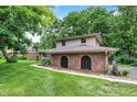 Two-story home with green grass and brick accents, offering a serene and inviting appeal at 4570 Moccosin Pl, Greenwood, IN 46142