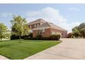 Well-maintained home exterior featuring a lush lawn and extended driveway at 4617 S Cobblestone Dr, Zionsville, IN 46077