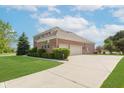 Beautiful red brick house with lush green lawn and well-manicured landscaping at 4617 S Cobblestone Dr, Zionsville, IN 46077