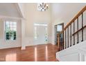 The grand foyer features hardwood floors, high ceilings, and classic white trim, creating an inviting entrance at 4617 S Cobblestone Dr, Zionsville, IN 46077
