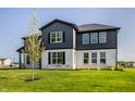Well-manicured two-story home with large windows and a spacious front yard at 4882 Morning Valley Ct, McCordsville, IN 46055