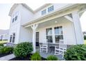 Charming front porch with rocking chairs and elegant white columns at 4992 Fennel Dr, Pittsboro, IN 46167