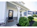 Inviting front porch with rocking chairs and well-maintained landscaping at 4992 Fennel Dr, Pittsboro, IN 46167