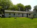 Large backyard with lush green grass, shed, and clothes line at 509 Eberhart Dr, Shelbyville, IN 46176