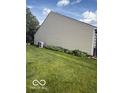 Side view of home showing well-maintained vinyl siding and manicured lawn at 5304 Appleseed Way, Indianapolis, IN 46217