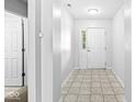 Bright foyer with neutral tile flooring, offering a glimpse of the interior with ample natural light at 5409 Brandywine Dr, Whitestown, IN 46075