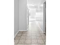 Clean hallway with tile flooring, leading to other rooms, showcasing a well-maintained and spacious layout at 5409 Brandywine Dr, Whitestown, IN 46075