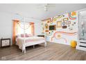 Spacious bedroom with unique wall art, natural light, and a decorative canopy bed at 6464 Whitley Ln, Indianapolis, IN 46260