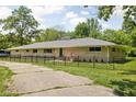 Ranch home featuring a fenced yard and charming exterior at 6464 Whitley Ln, Indianapolis, IN 46260