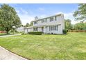 Well-maintained two-story home with a manicured lawn, two-car garage, and lovely blue shutters at 6601 Valley Forge Ct, Indianapolis, IN 46237