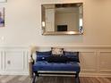 Inviting foyer with a stylish blue bench, decorative pillows, silver vase, and framed mirror at 6731 Keepsake Dr, Whitestown, IN 46075