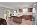 Inviting kitchen features a central island, dining space, and modern appliances at 7171 E Rising Sun S Cir, Camby, IN 46113