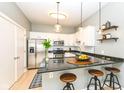 Modern kitchen with granite countertops, stainless steel appliances, and a breakfast bar at 721 E North St # 2C, Indianapolis, IN 46202
