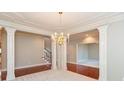 Dining room with detailed ceiling, columns, and a chandelier at 725 Ridge Gate Dr, Brownsburg, IN 46112