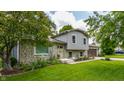 Charming two-story home featuring a stone facade, well-maintained landscaping and inviting curb appeal at 8015 Ridgegate East Dr, Indianapolis, IN 46268