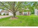 Charming single-story home with well-manicured lawn, mature shade tree, and inviting brick accents at 8315 Exton Rd, Indianapolis, IN 46239