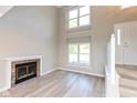 Living room features a fireplace, large windows, and new vinyl flooring at 8955 Stonegate Rd # A, Indianapolis, IN 46227