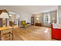Bright living room with hardwood floors, a large window, and classic furnishings at 1010 Maple St, Greenwood, IN 46142